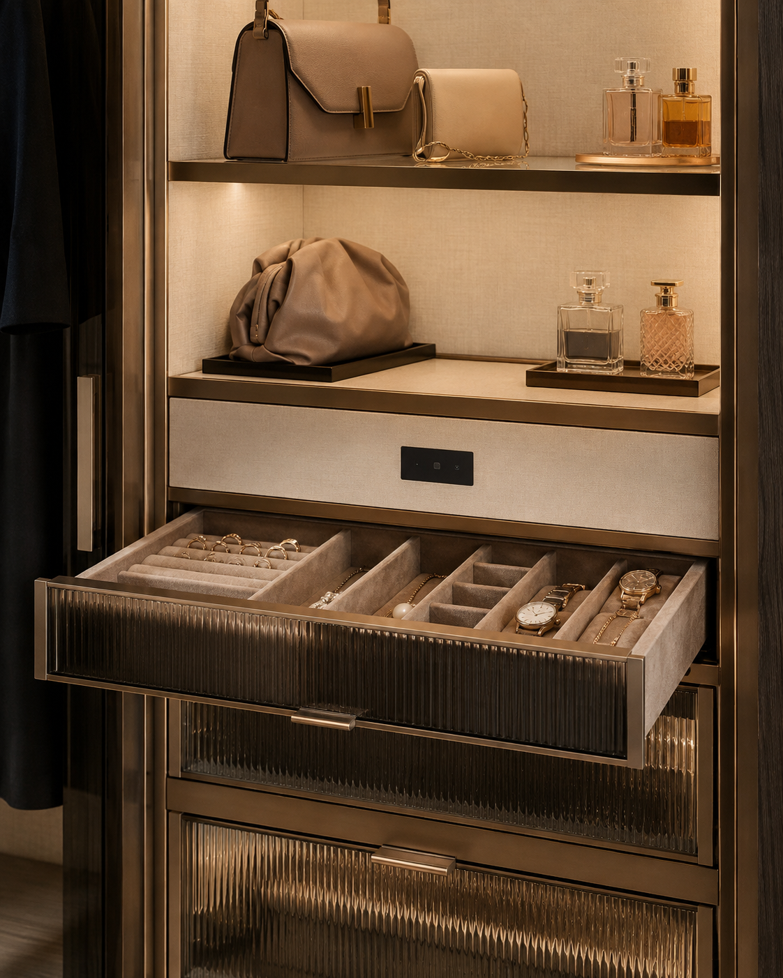 Bronze walk-in wardrobe with lit shelves, fluted glass drawers and velvet jewellery tray
